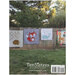 Back of the pattern book showing several finished quilts staged on a wooden fence outdoors