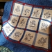The Snowman by the Dozen designs as a quilt, in blue, cream, and red.