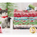 fabric stack, in retro shades of green, red, pink, blue, and black next to a cat figurine in front of a christmas tree
