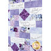 Close up photo of a purple, blue, and white quilt made with a psalms panel, showing details