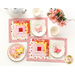 A top down shot of the completed mats staged on a white table with a teapot, teacups, butterfly shaped cookies, and a jar of coordinating pink flowers.