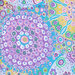 close up of Fabric featuring vibrant multicolor kaleidoscopic abstract designs, shaped around circles.