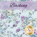 A light blue fabric with large sprawling shabby florals in blue, cream, and wisteria purple. A purple banner at the top reads, 