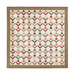 The completed quilt in warm browns, muted cream, gentle red, and mossy green, isolated on a white background.