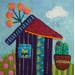 A close up of one of the blocks, showing a house with a raincloud gently raining on a cactus; a hand embroidered cat can be seen in the window of the house.