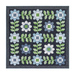 The Edelweiss quilt, completed in navy blue, powder blue, green, and white, isolated on a white background.