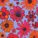 Upclose image of Periwinkle fabric with bright, varying tossed orange and red florals.