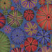 close up of Medium blue print with round sea urchins of varying sizes in red, green, purple, and royal blue.