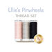Three spools of thread in baby pink, grey, and black, isolated on a white background below the text graphics 