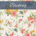 A light cream fabric with ornate tossed florals in pink, yellow, green, and blue. A navy blue banner at the top reads 