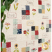 A close up of a playful beige quilt with colorful blocks, and words such as 