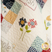 A close up of the colorful quilt blocks in the Bloom quilt