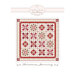 Front of the pattern, featuring an image of the finished quilt in red, pink, and cream