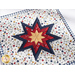 A closer look at the square hot pad, showing fabric and stitching details on the folded star center.