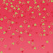 A dark pink fabric with small golden and red hearts scattered all over
