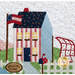 A close up on a block featuring a striped red house that has a waving flag in the front yard and a quilt on a laundry wire in the backyard.