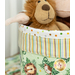A super close up on the top part of the fabric basket, showing fabric and stitching details on the striped and polka dot prints of the project. The stuffed lion and monkey can be seen peeking out of the basket.
