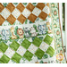 A close up on the camel brown and leaf green on-point square rows of the quilt, showing fabric and stitching details.