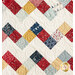 A close up on the zigzag patchwork of the Frolic quilt, showing fabric and topquilting details.