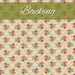 A swatch of cream fabric with tiled bouquets of pink, blue, and red flowers. A green banner at the top reads 