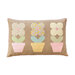 The completed Potted Flowers Pillow in light brown and gentle pastel shades, isolated on a white background.