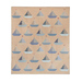 The completed Sailboat quilt in sandy tan and shades of dusty blue, sky blue, and denim, isolated on a white background.