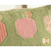 A super close up on one of the apples of the pillow, demonstrating fabric, piecing, and topstitching details.