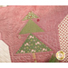 A close up on the Christmas tree of the pillow, showing top quilting and embellishment details. 