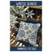 Front of pattern showing the completed cross stitch on a pillow displayed on a table with snowflake and pinecone props