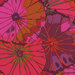 Close up of bright red fabric with overlapping crimson, bright red, and pink lotus leaves all over