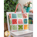 The completed Magic Charm Tote, colored with vibrant colors from the Strawberry Lemonade collection. The bag is staged with coordinating plants and furniture.