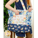 Colored in blue, navy, white, and rainbow fabrics from the Love and Learning collection, a model wears the Carry-It-All bag over their shoulder, utilizing the front pocket.