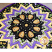A close up on the center of the table topper, showing details on the hives and flowers circling the center.