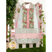 The completed blue Clothing Coverall, colored in sky blue, light pink, and gentle green. The coverall is staged on a white picket fence with matching pink roses and a leafy houseplant.