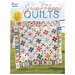 front of the Scrap Happy Quilt book showing finished quilt projects hanging on a clothesline