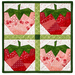 The completed June wall hanging, a pink, red, and green collage of four juicy strawberries, isolated on a white background.
