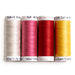 Four spools of brightly colored thread, arranged in rainbow order and isolated on a white background.