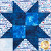 A close up on a vibrant blue sawtooth star block, showing fabric and top quilting details.