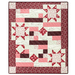 The completed Comfort of Psalms quilt in Blushing Blooms, a collection of red, pink, and cream floral fabrics, isolated on a white background.