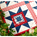 A super close up on the log cabin sawtooth star block, demonstrating fabric, piecing, and stitching details.