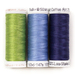 Three spools of thread in green, cornflower blue, and dark midnight blue, isolated on a white background.