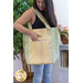 A shot of a model carrying the jelly roll tote, opening a roomy pocket on the side.
