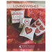 Front of Loving Wishes cross stitch pattern showing the finished pillows displayed in a large bowl on a blanket