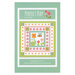Front cover of the pattern showing a digital mockup of the completed Perfect Day quilt in bright cheerful colors on an aqua background.