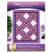 Front cover of the pattern showing the completed Easy Irish Chain Throw Quilt in vibrant shades of purple, magenta, and white, hung on a white paneled wall and staged with coordinating furniture and decor.