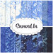 A stacked collage of blue and white mottled batiks with winter motifs