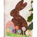 A shot of the Happy Easter Door Banner at a slight angle; a leafy houseplant peeks into frame from the right side.