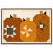 A quilted project featuring three stylized pumpkins in orange, cream, and black fabrics with geometric patterns, isolated on a white background.