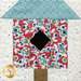 A super close up on one of the bird house blocks, demonstrating fabric and top quilting details.