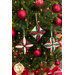 The three completed ornaments hanging on a decorated Christmas tree with wrapped presents peeking out from the bottom of the shot.
